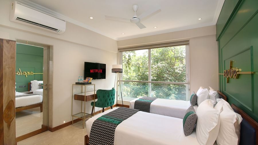 An image of a beautiful room with twin beds and open window from where sunlight is seeping in - Theory9 - Premium Service Apartments, Bandra