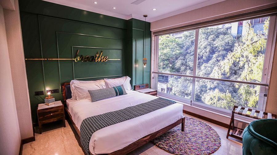 bedroom with modern interior and expansive window overlooking the city