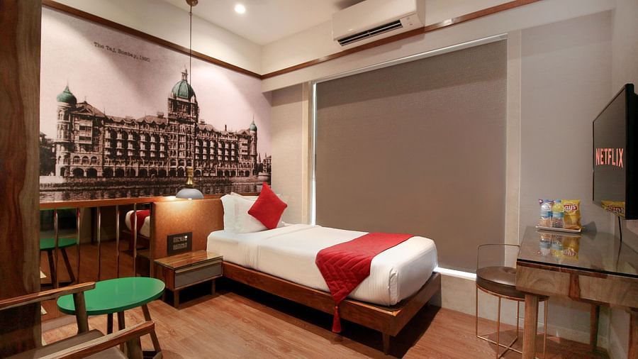 modern rooms with single bed and windows offering the panoramic views of mumbai