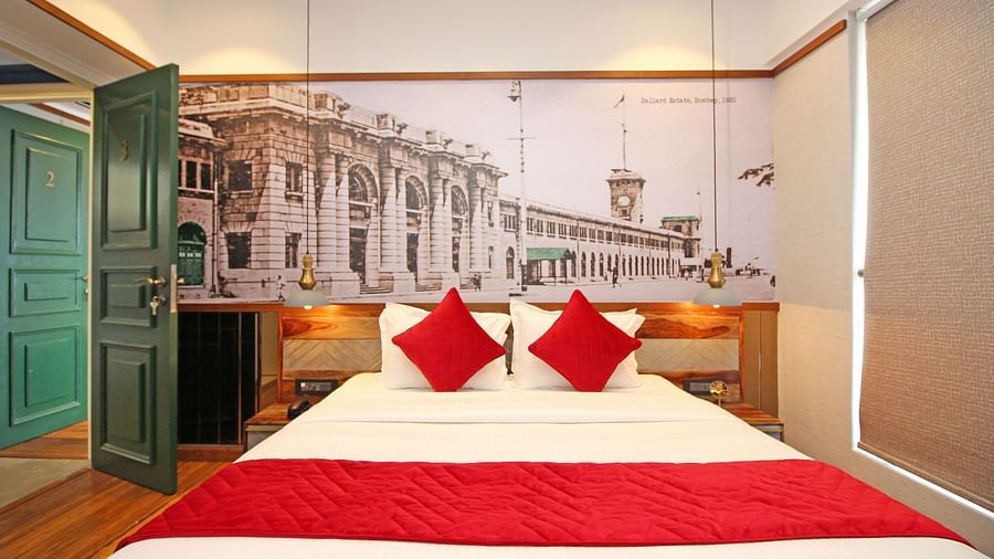 king size bed with a green door at one of the best service apartments in khar