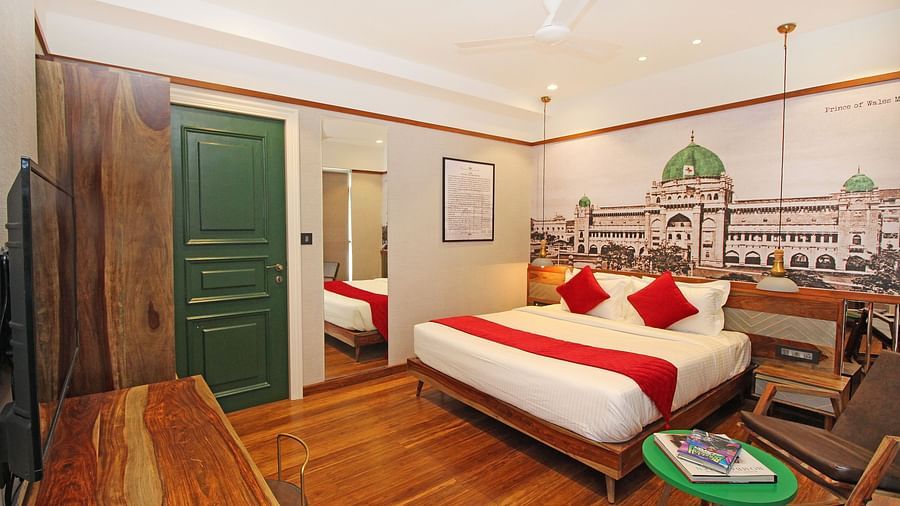 An image of a bedroom with green door and wooden furnishings at Theory9 - Premium Serviced Apts, Khar
