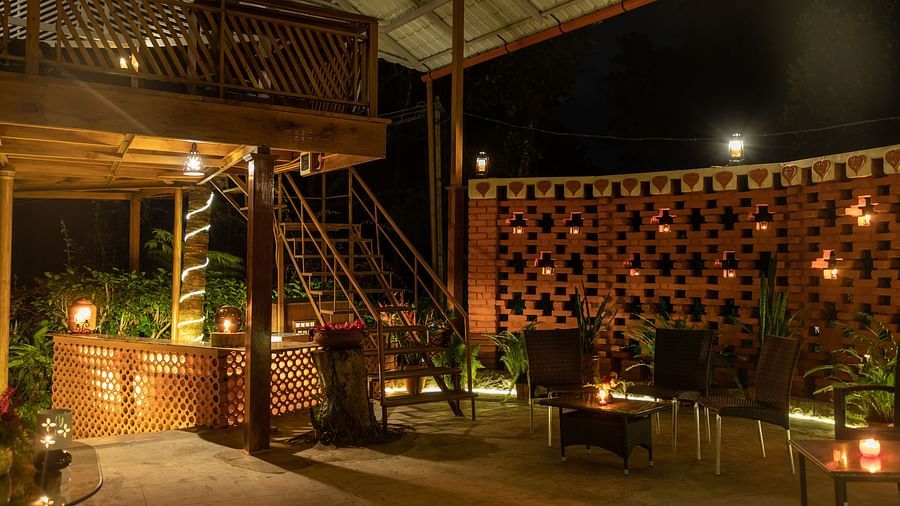 A staired wooden deck above a bunch of chairs, with bright LED lights adding subtle charm.