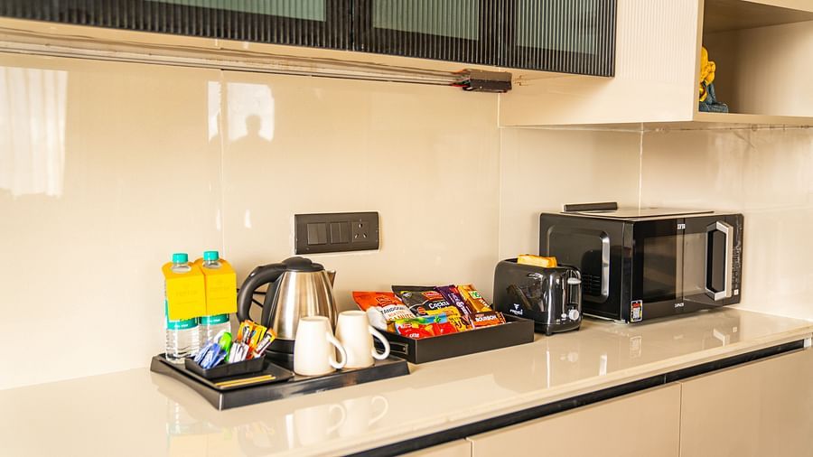tea/coffee maker and microwave in the presidential suite at Triptam Hotel, Vrindavan