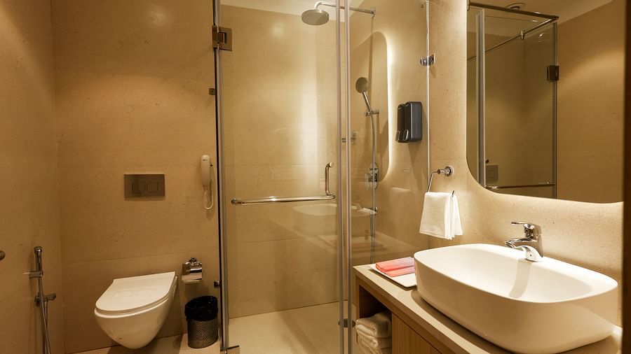 A minimalist bathroom with a separate shower  cubicle and a vanity counter - Tulip Inn, Zirakpur