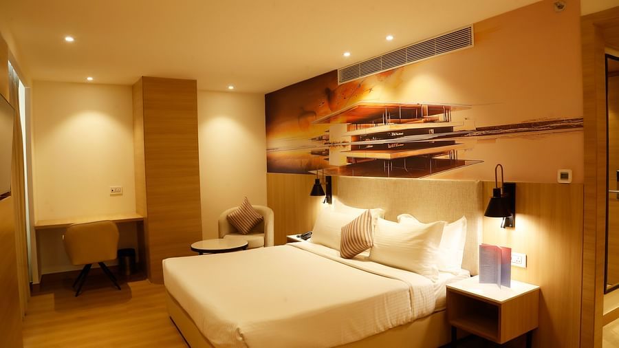 A suite with a king size bed with minimalistic decor and modern lighting - Tulip Inn, Zirakpur
