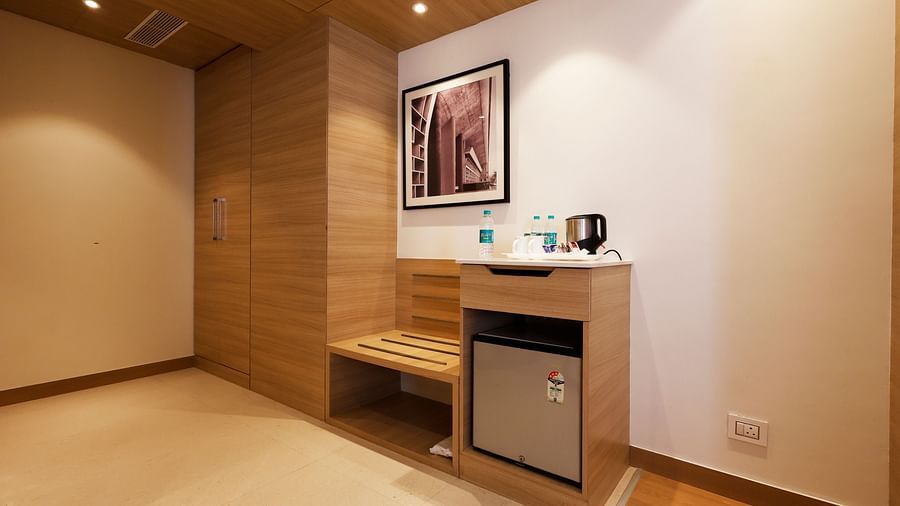 An image of a minibar, an electric kettle and a cupboard in a cosy corner of our hotel room - Tulip Inn, Zirakpur