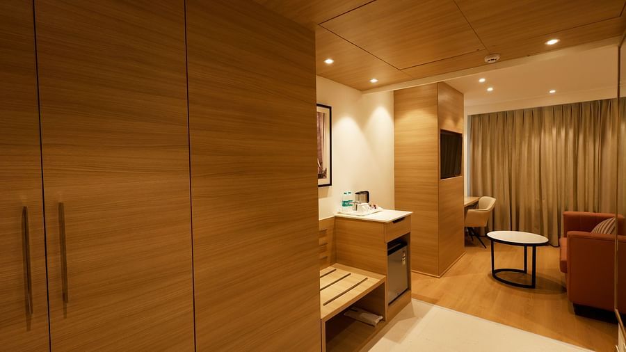 The executive suite with a cosy couch and a minibar seen from the side of a cupboard - Tulip Inn, Zirakpur