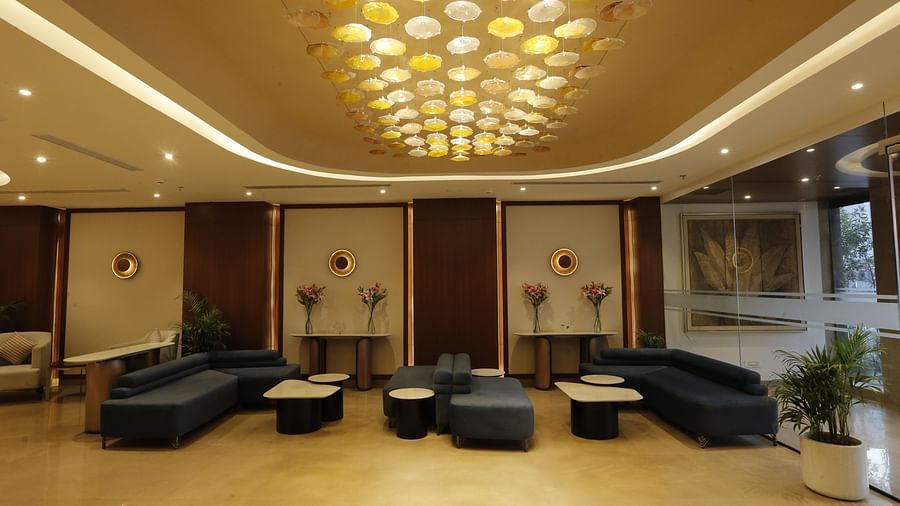 A poster of a huge lobby featuring sofa sets and lights installed in the ceilings - Tulip Inn Zirakpur