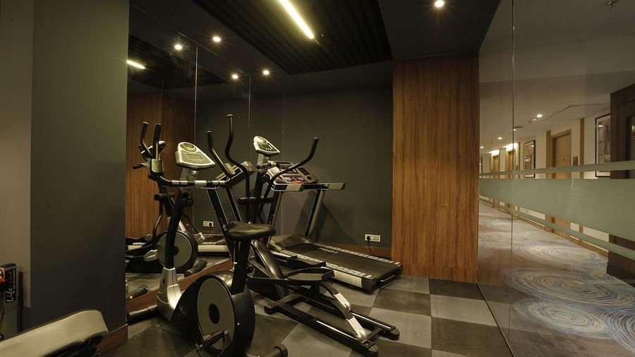 An image of a gym featuring cycles and treadmill along with other equipment at Tulip Inn, Zirakpur