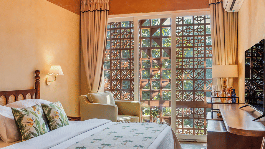 Elegant bedroom at Unseen Boutique Hotel with soft lighting, floral accents, and a welcoming atmosphere blending comfort and charm.