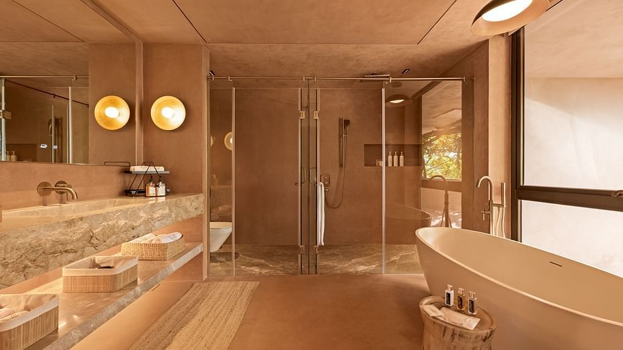 Bathroom area with luxurious setup with a bath tub, sink area and shower area and marble flooring at V Escapes Moira