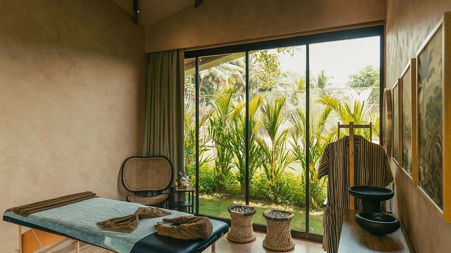 A spa bed at Villa Moira by V Escapes, with ample of natural light coming from the large window overlooking lush greenery.