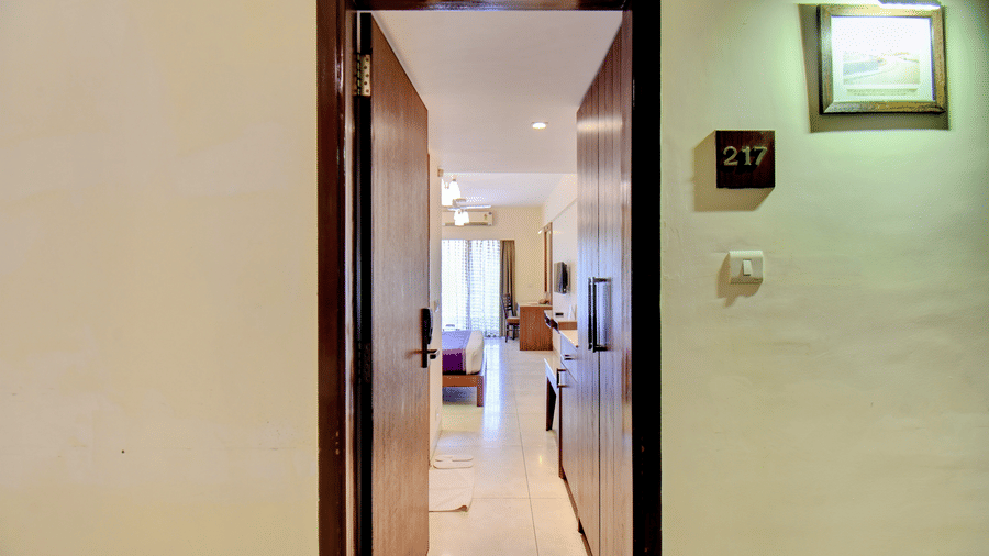 Interior hallway view leading to spacious and well-lit room at VITS Lonavala.