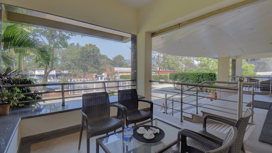 Cozy terrace seating area with scenic greenery views at VITS Lonavala.