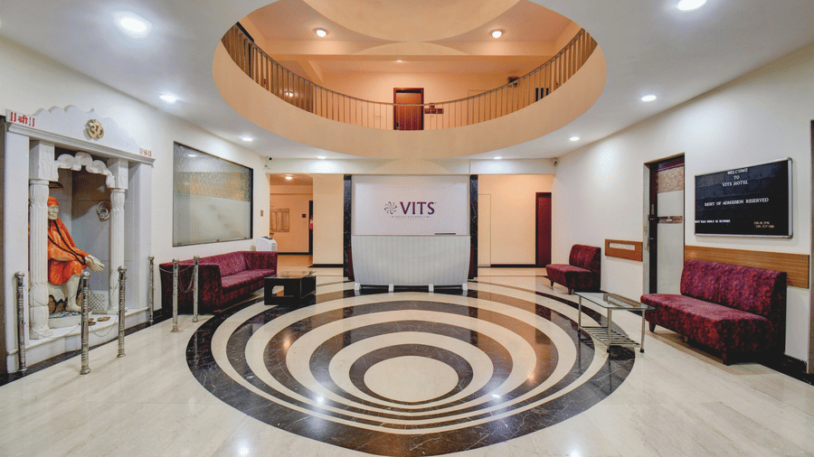 Grand lobby with circular floor design and reception area at VITS Lonavala.