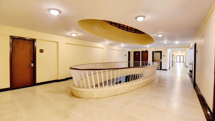 Bright hallway with open atrium view and guest room access at VITS Lonavala.