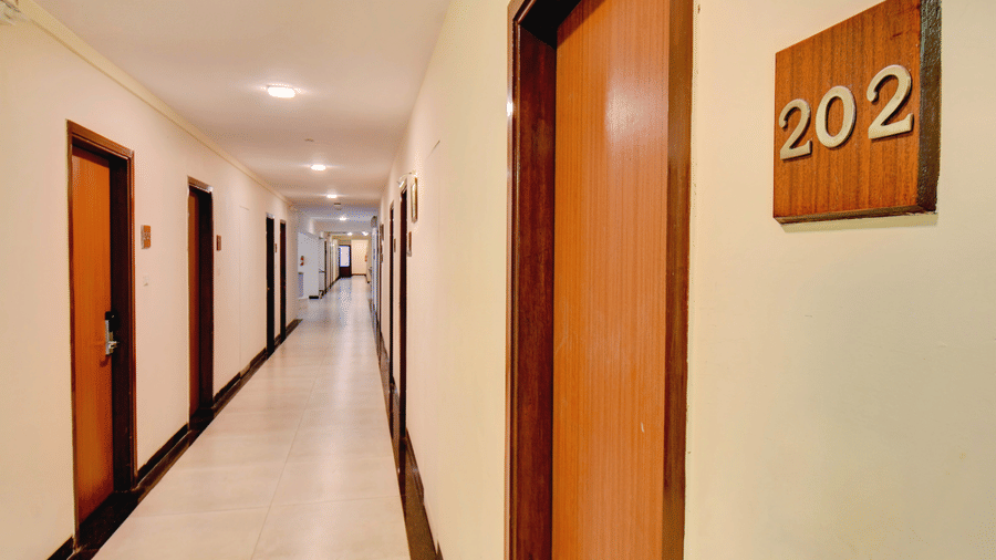 Guest room corridor with room number signage at VITS Lonavala.