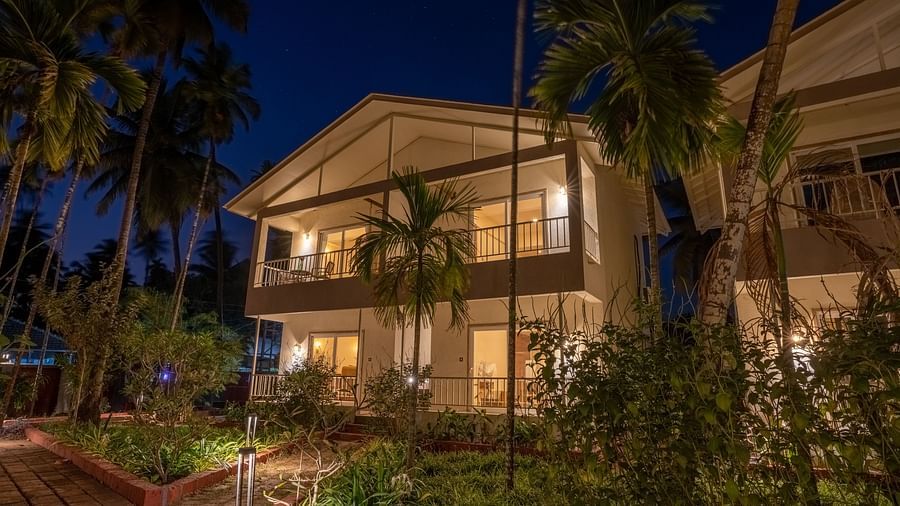 Facade image of VITS Select Casuarina Diveagar with greenery around it during the night