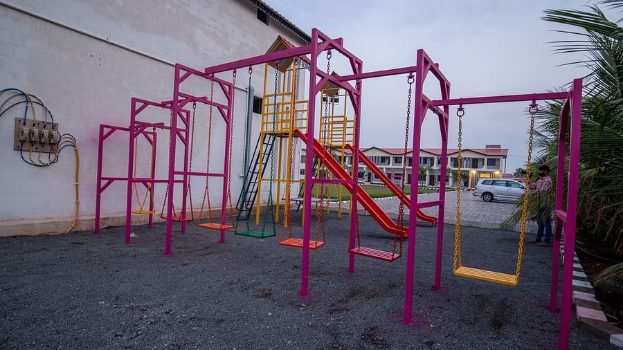 A close-up view of a playground slide, surrounded by swings and climbing frames in a well-maintained outdoor area - VITS Select Diamond Resort, Sasan Gir