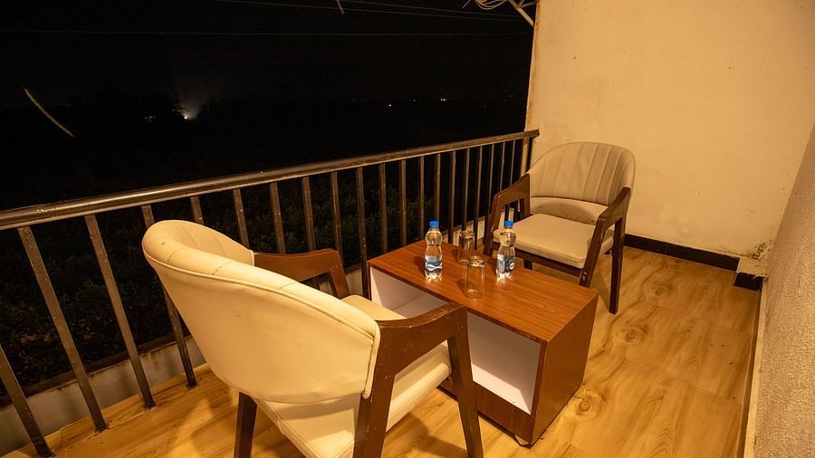 corner view image of the seating area in the balcony of the suite with two chairs placed opposite to each other - VITS Select Diamond Resort, Sasan Gir