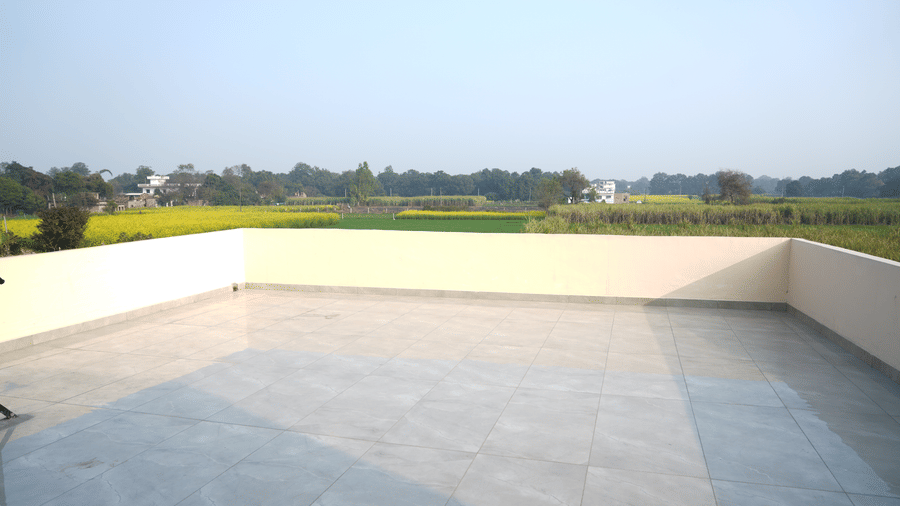  Spacious rooftop terrace with open views of the surrounding green fields and landscape.