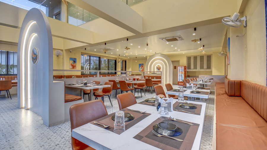 Restaurant interior with buffet counters and seating arrangement at VITS Select Nashik Hotels & Resorts.