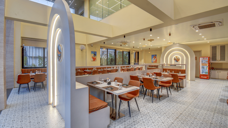 Dining area with seating and bright interiors at VITS Select Nashik Hotels & Resorts.