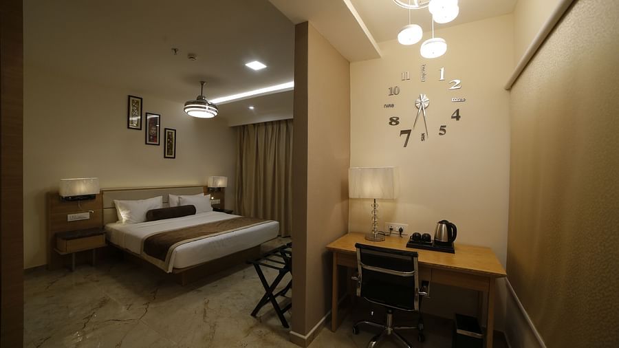 image of a king size bed with work desk provided in superior room at voyage annapurna de royal, guntur