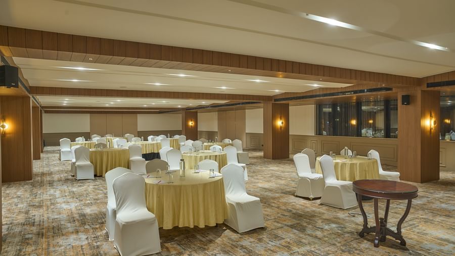 Spacious banquet hall with seating at Voyage Milestone Hotel and Banquet.