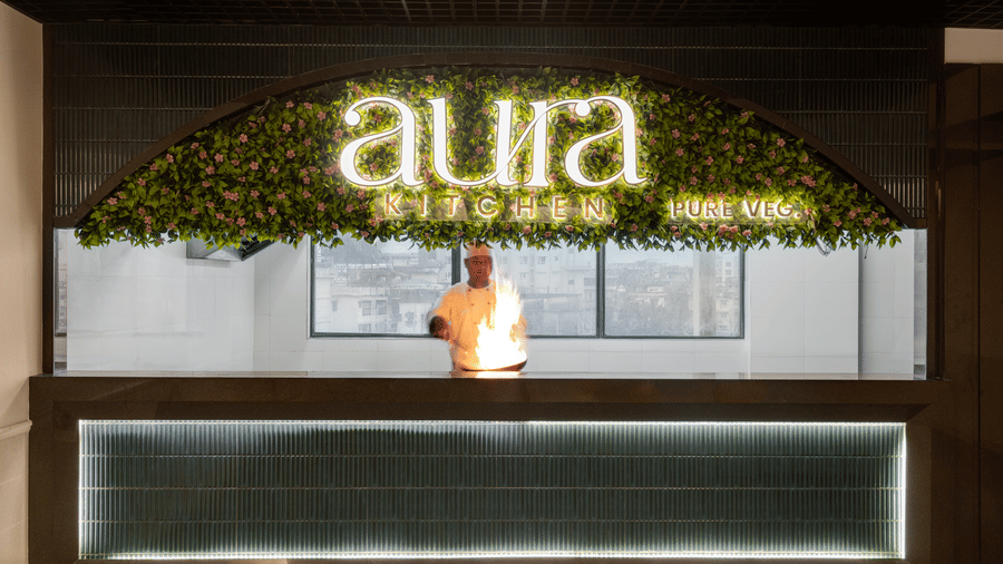 A chef at Aura Kitchen at Voyage Milestone Hotel And Banquet cooking as the flame is rising from the pan
