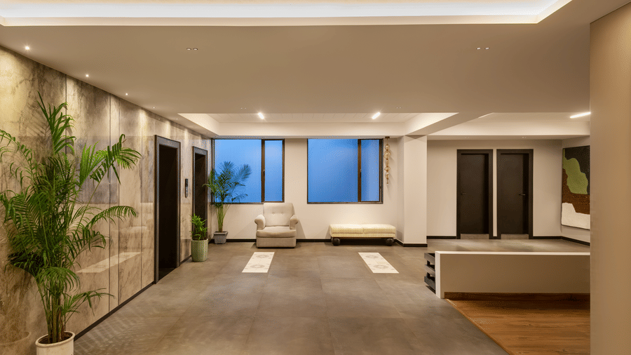 Seating area at Aura at Voyage Milestone Hotel And Banquet featuring couch next to the window and a sofa facing 2 doors
