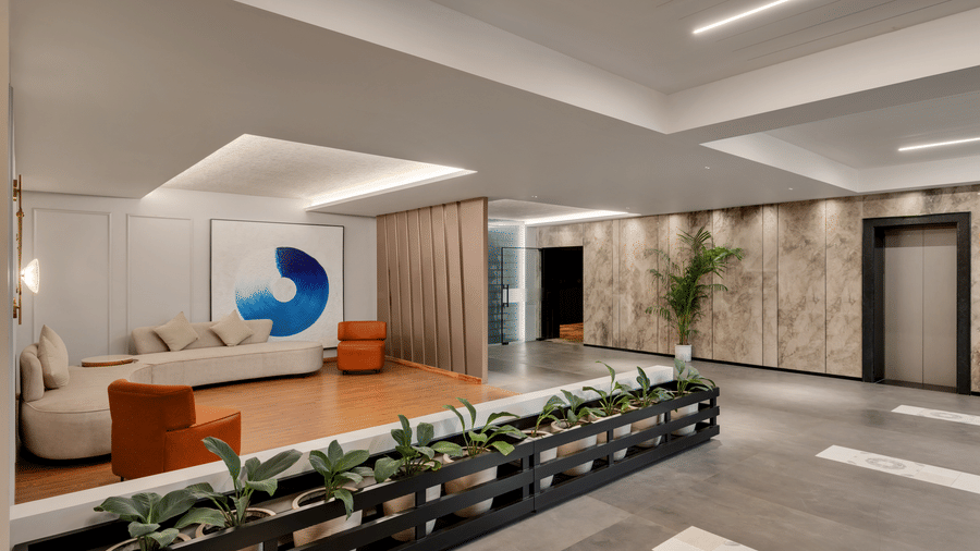 Aura at Voyage Milestone Hotel And Banquet featuring a seating area with L-shaped sofa and 2 couches on both ends under ambient lighting