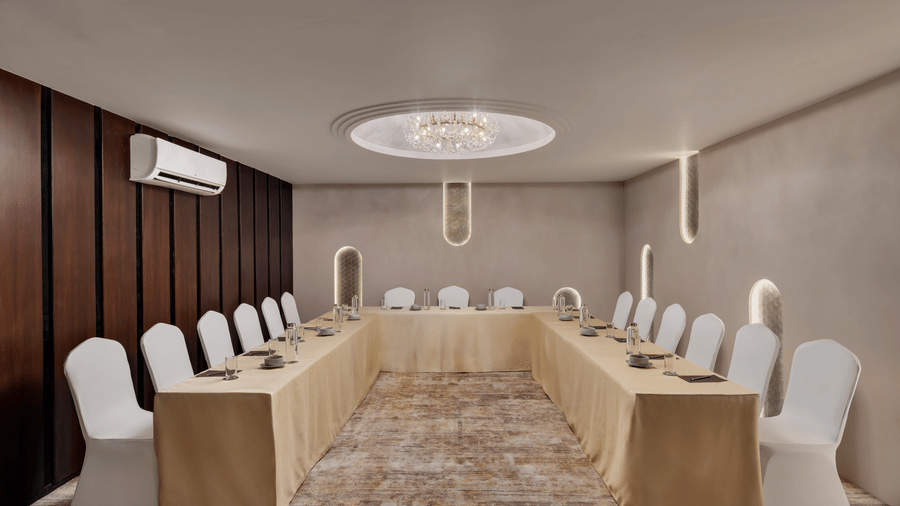 U-shaped seating arrangement at Aura at Voyage Milestone Hotel And Banquet under warm lighting
