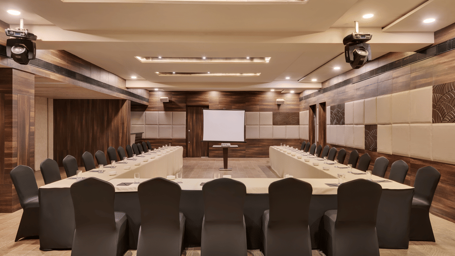 Spectrum hall at Voyage Milestone Hotel And Banquet featuring a projector surrounded by chairs arranged in U shape