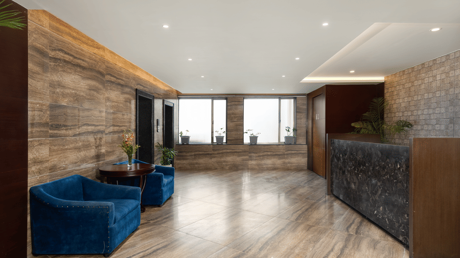 Spectrum at Voyage Milestone Hotel And Banquet featuring a seating area in front of a reception desk with 2 windows in the distance