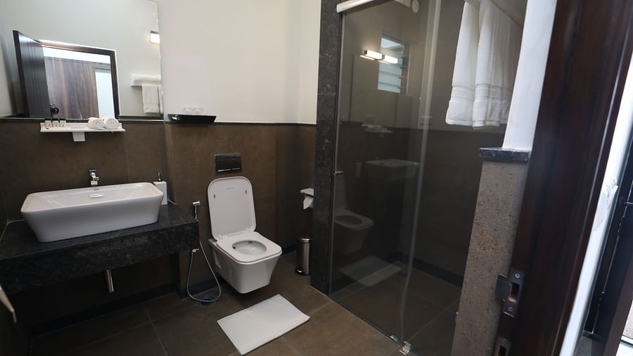 Washroom with glass shower cubicle and white ceramics