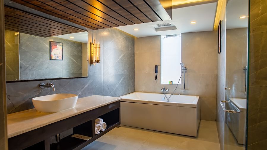 overview of the bathroom with a bathtub inside one of the rooms - Wedlock Greens Hotel Resorts Dhanbad