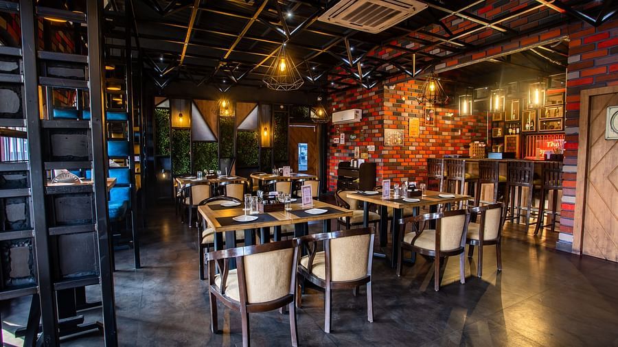 seating arrangements inside a restaurant - Wedlock Greens Hotel Resorts Dhanbad