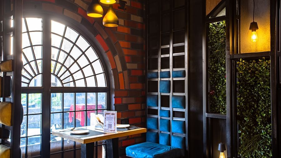 seating arrangements inside a restaurant - Wedlock Greens Hotel Resorts Dhanbad