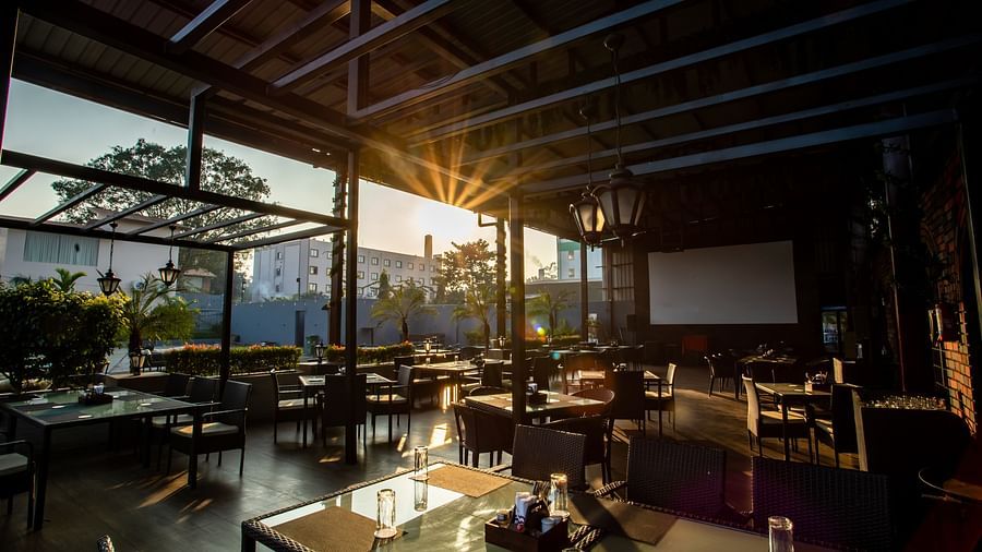 seating arrangements inside a restaurant - Wedlock Greens Hotel Resorts Dhanbad