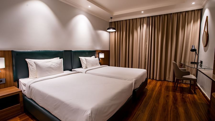 twin beds with led lights on inside one of the rooms - Wedlock Greens Hotel Resorts Dhanbad
