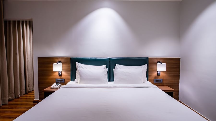 a double bed with led lights on inside one of the rooms - Wedlock Greens Hotel Resorts Dhanbad