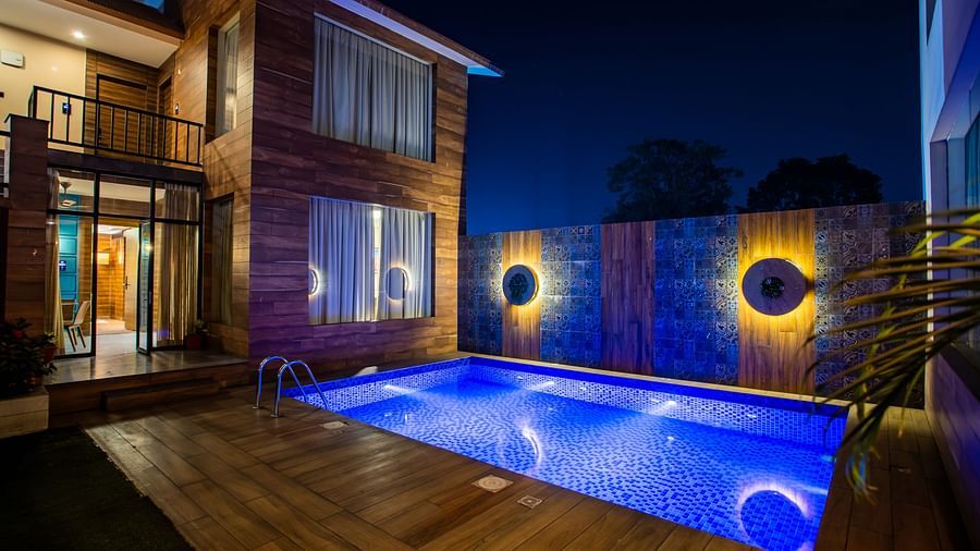 facade image of a building with a swimming pool in front in the night - Wedlock Greens Hotel Resorts Dhanbad