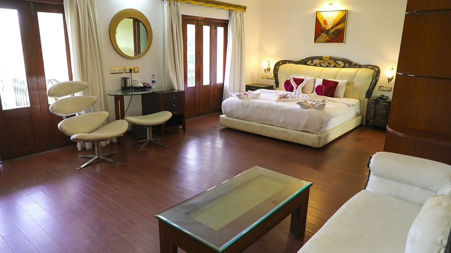 a king bed with sofas inside King Suite - White pearl suites by rosetum 