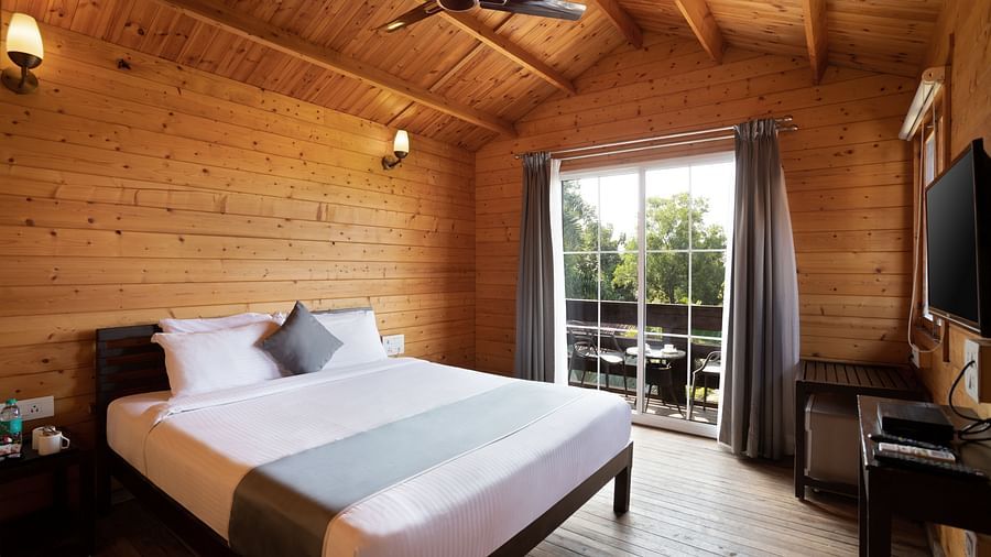 A side view of the wooden cottage room interior - White Wood Resort, Morjim