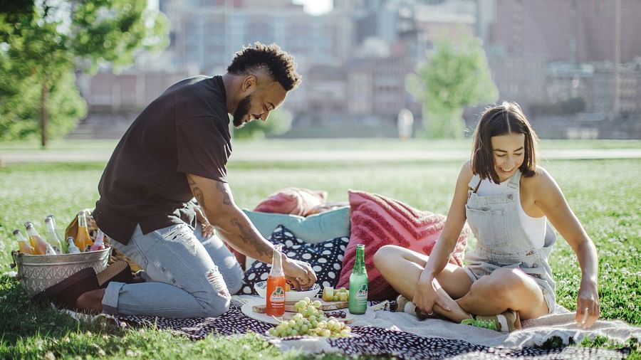 A couple sitting in an open lawn