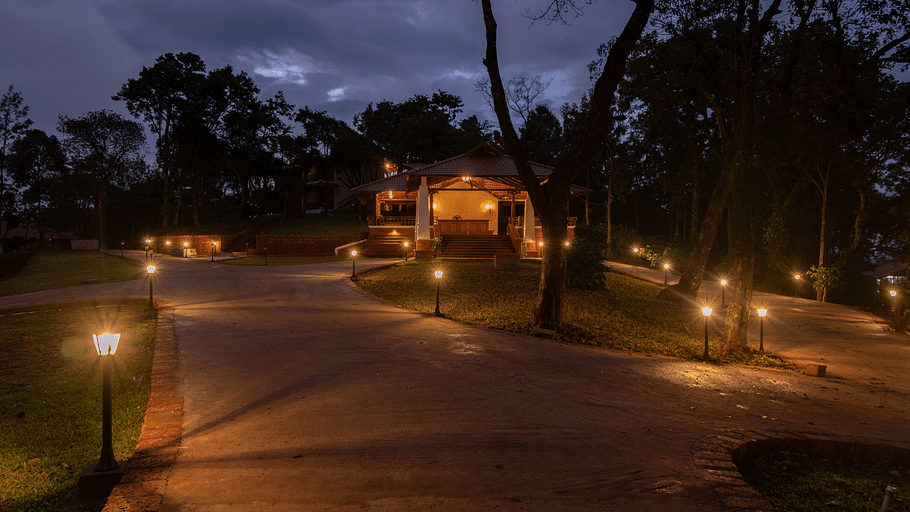 Night time view of the resort with lights switched on the side of the pathway at TGI Tapovana
