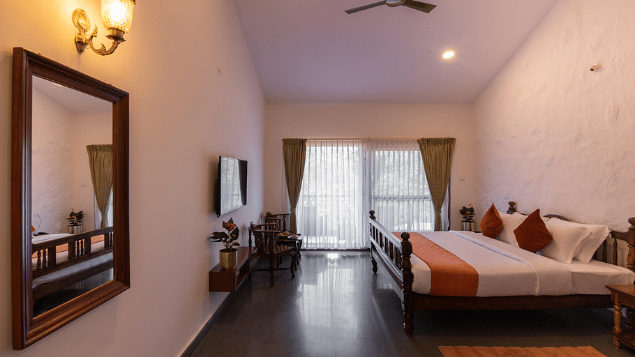 wide angle view of the Hilltop Cottage with a large mirror television coffee table and more - Trishvam Tapovana, Sakleshpura