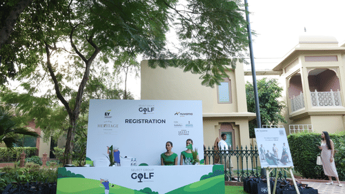 Interactive putting green set up at a golf event with branded signage