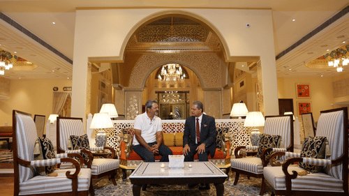 Elegant seating area in a lavish hotel lobby, with guests enjoying a relaxed conversation.
